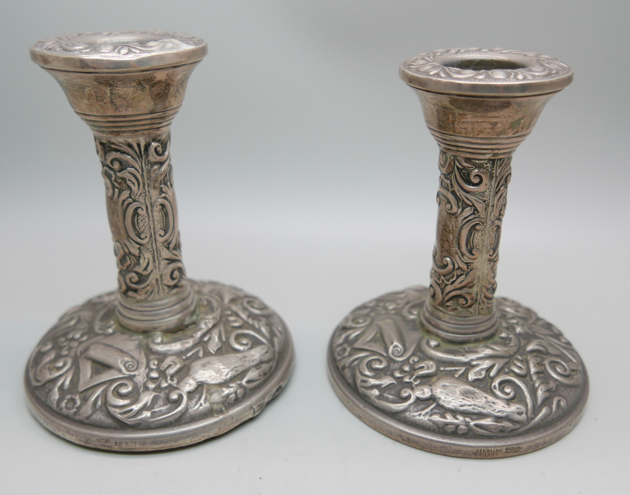 A pair of silver embossed candlesticks, W. I. Broadway & Co., Birmingham 1953/54, 10cm