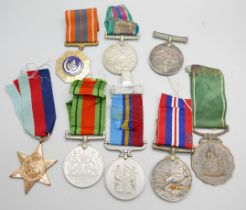 Eight medals, including two Africa Service Medals to 592810 D.T. Howells and 133965 C.W. Chapman