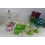 A large polka-dot decorated punch bowl and plastic ladle, other coloured glass vases; red, green,