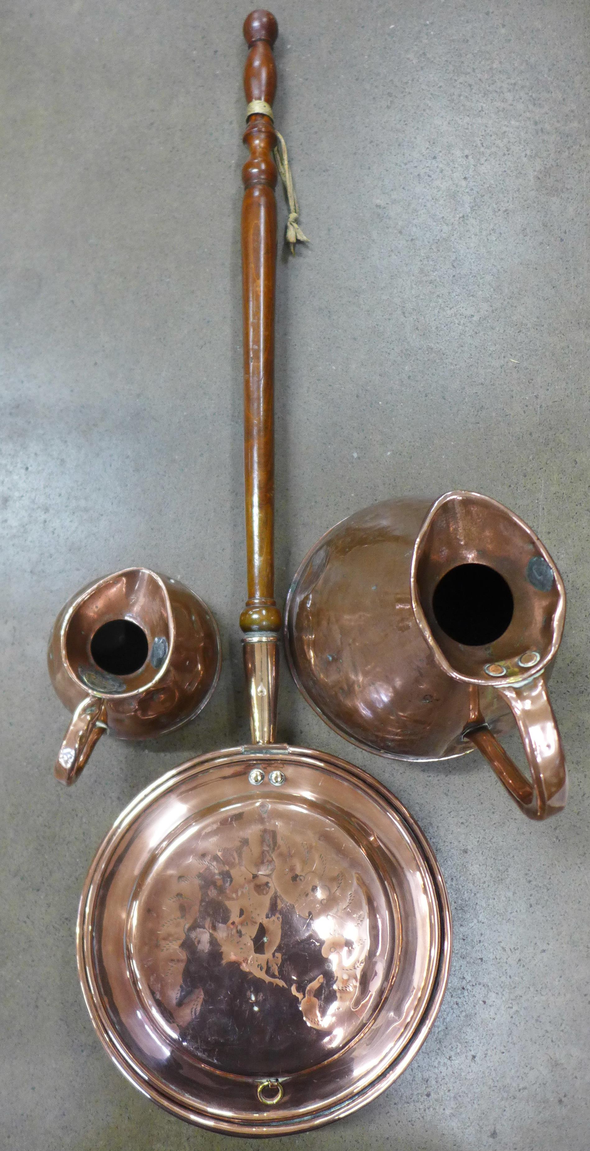 A copper flagon, Imperial 1 gallon and a smaller copper flagon and a copper warming pan