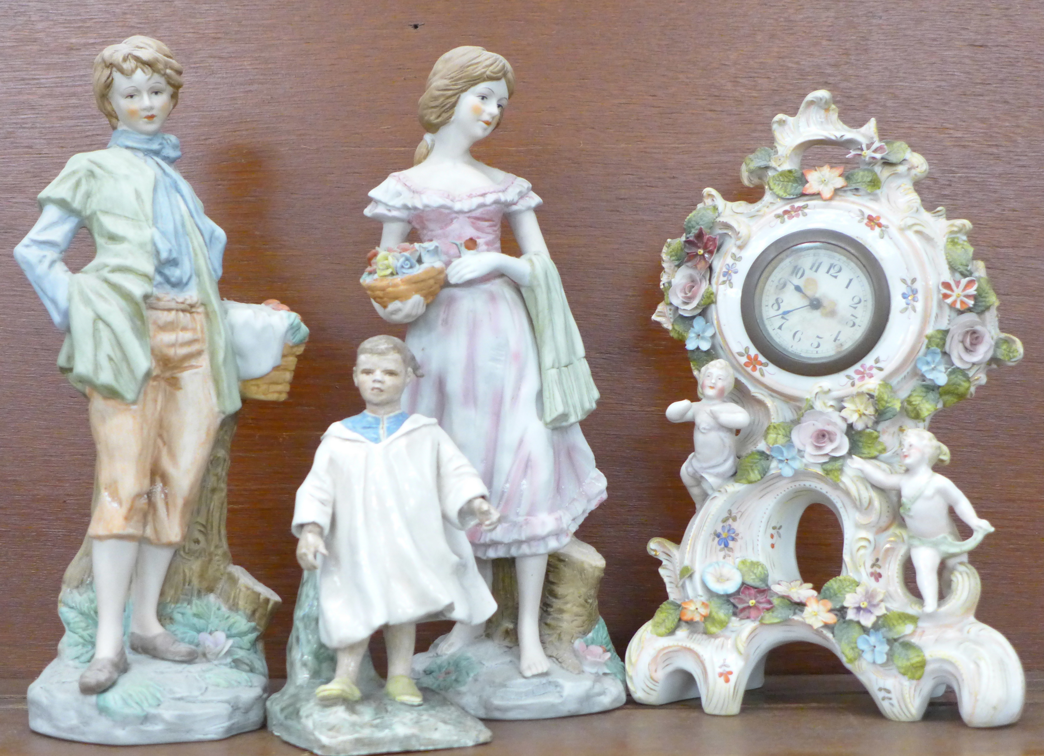 A cherub porcelain mantel clock, a hand painted porcelain ceramic Johnny Appleseed figure, hand