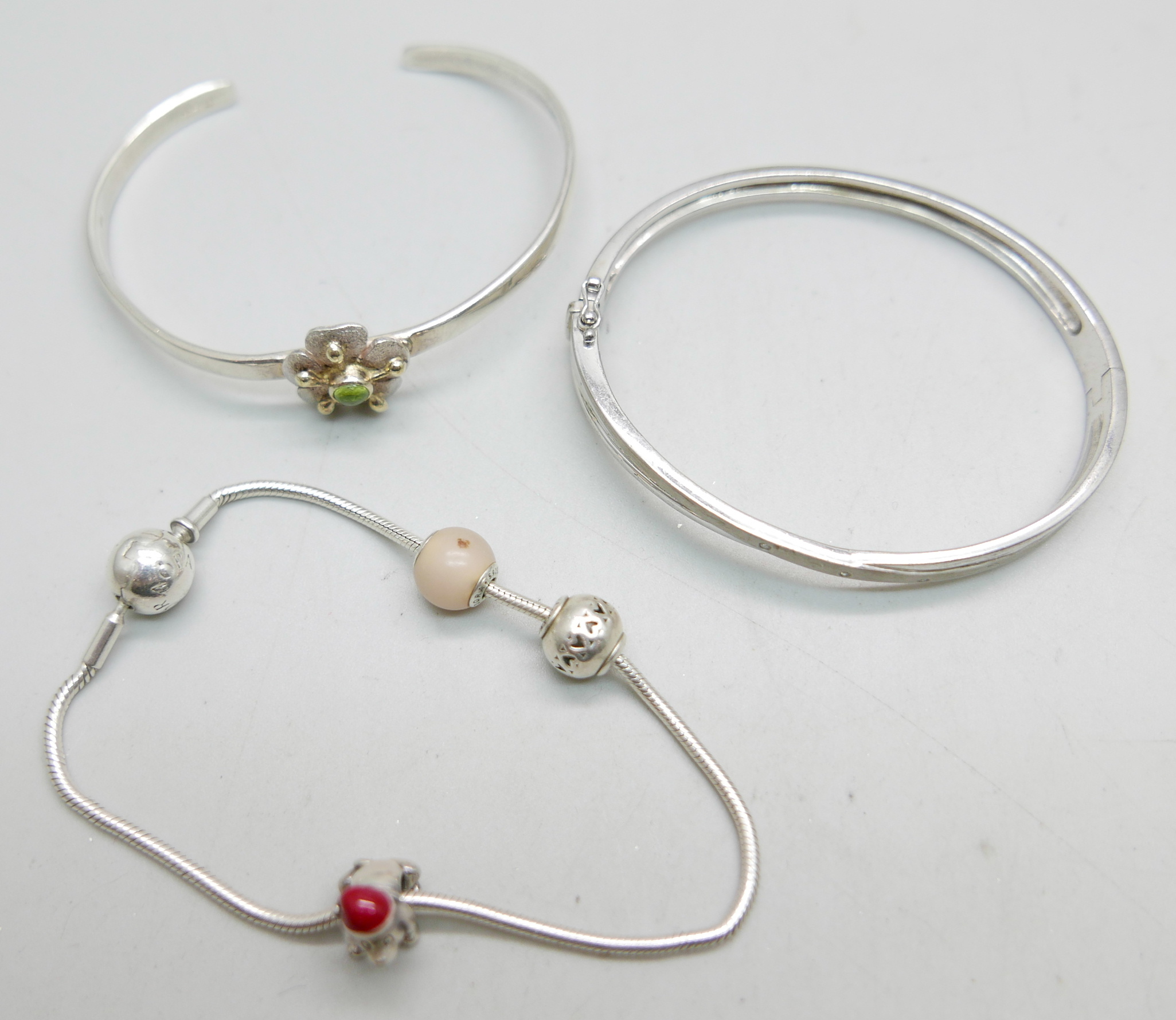 Two silver bangles and a Pandora bracelet