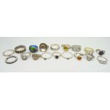 Eleven silver rings and seven white metal rings, one lacking stone, 75g
