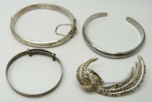 Two silver bangles, one other bangle and a marcasite set brooch