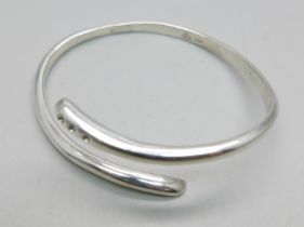 A silver and diamond set bangle, 27g