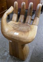 A hardwood hand shaped stool