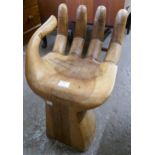 A hardwood hand shaped stool