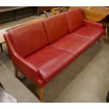 A Danish Thams Kvalitet crimson leather three seater sofa, designed by Rud Thygesen