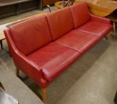 A Danish Thams Kvalitet crimson leather three seater sofa, designed by Rud Thygesen