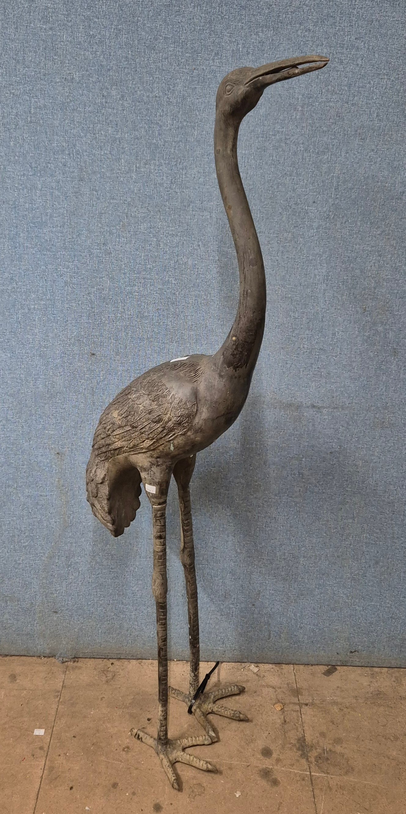 A large bronze garden figure of a crane