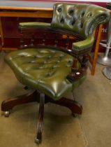 A mahogany and green leather revolving Captain's desk chair