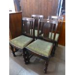 A set of four carved oak dining chairs