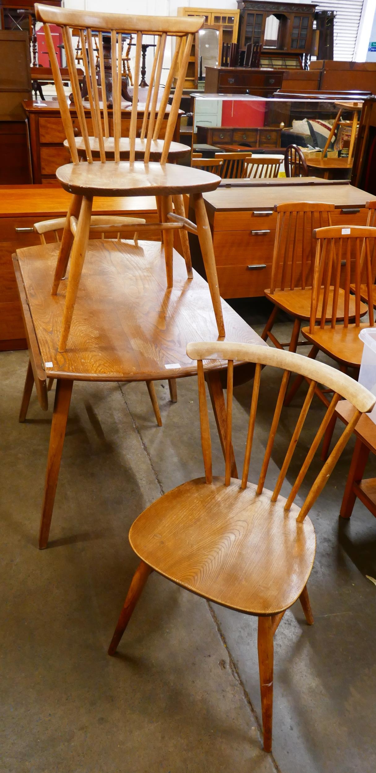 An Ercol elm and beech Windsor drop leaf table and four chairs