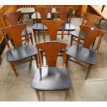 A set of eight teak and black vinyl dining chairs