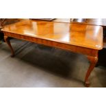 A Queen Anne style walnut dining table