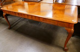 A Queen Anne style walnut dining table