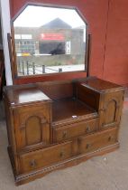 A carved oak dressing table