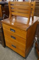 A teak chest of drawers and a magazine rack