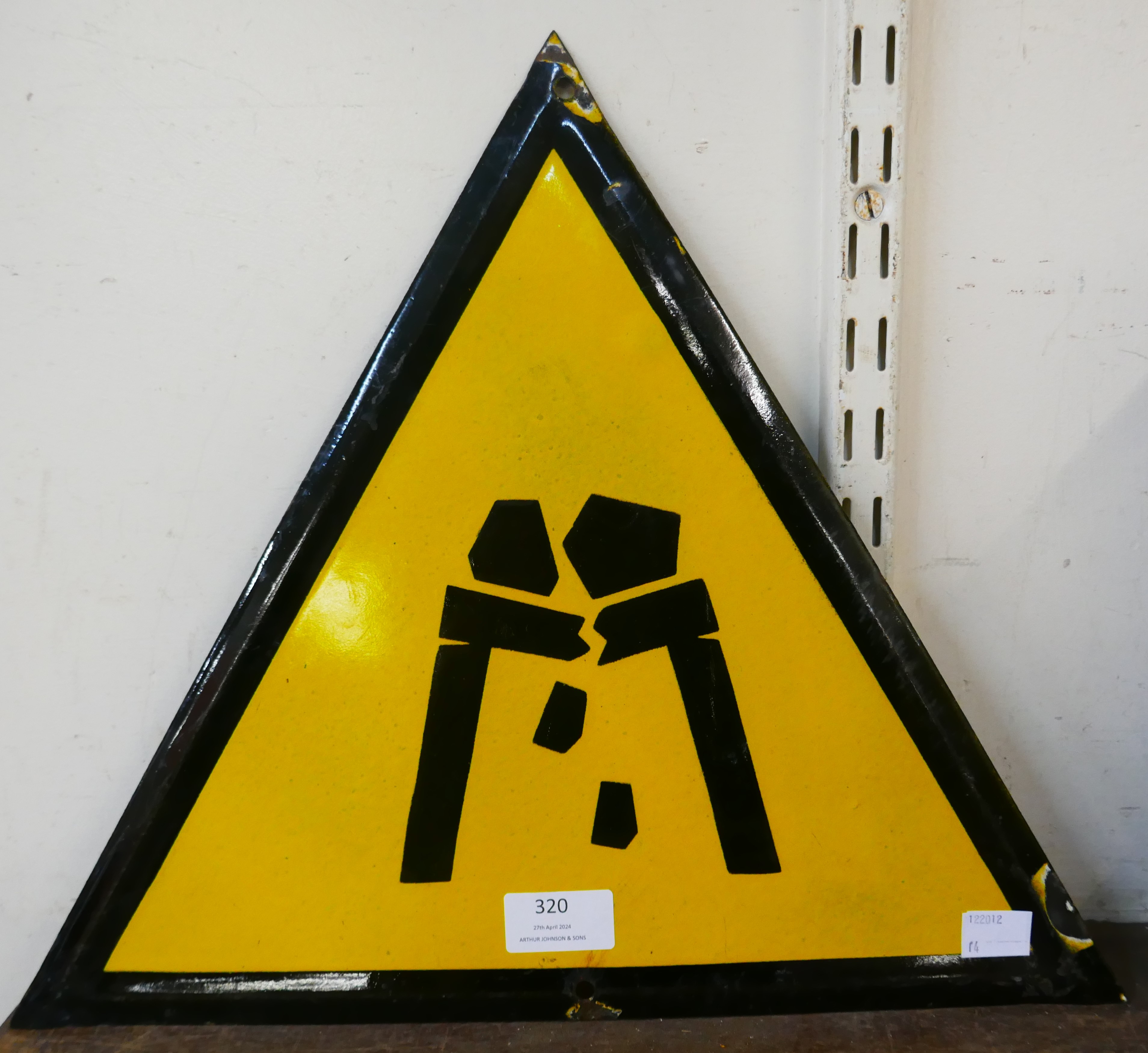 An enamelled metal Falling Rocks warning sign