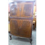 An inlaid mahogany bow front cocktail cabinet