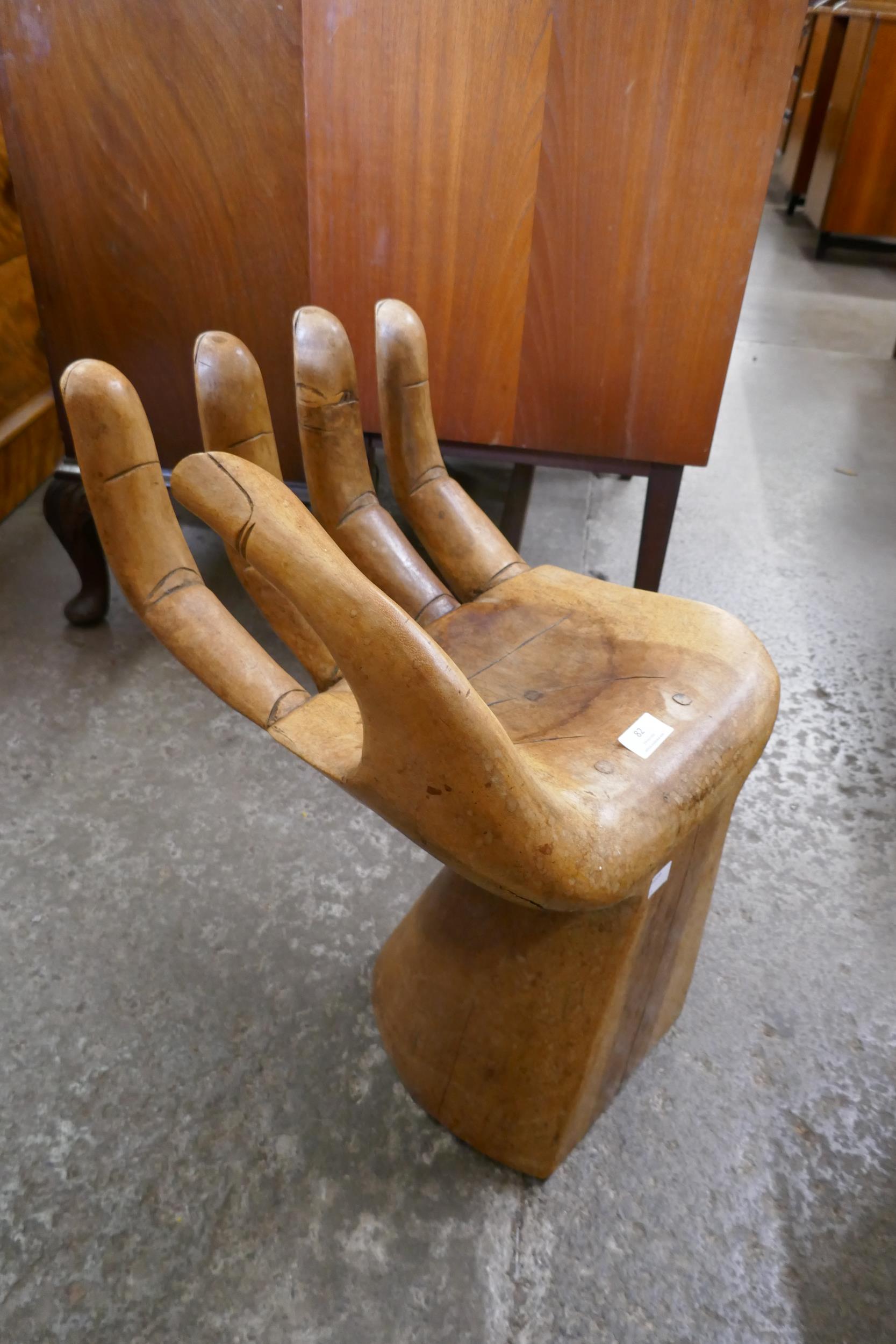 A hardwood hand shaped stool - Image 2 of 2