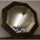 An embossed brass octagonal framed mirror