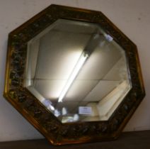 An embossed brass octagonal framed mirror