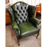 A Thomas Lloyd green leather Chesterfield wingback armchair