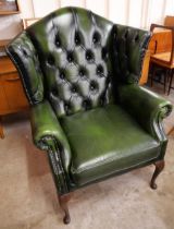 A Thomas Lloyd green leather Chesterfield wingback armchair