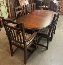 An oak extending dining table and six chairs