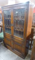 A carved oak linenfold bookcase