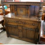 A carved oak linenfold court cupboard