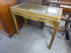 An Oriental carved hardwood console table
