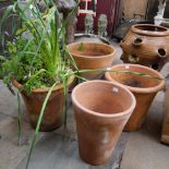 A set of four large terracotta plant pots