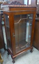 A George III style mahogany single door display cabinet