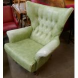 A G-Plan Blofeld 6520 model revolving green vinyl wingback lounge chair