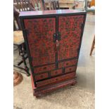 A small oriental red lacquered chinoisiere cabinet cabinet