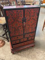 A small oriental red lacquered chinoisiere cabinet cabinet
