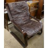 A bentwood and brown patchwork leather armchair