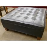 A black leather ottoman