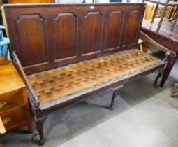 A George III panelled oak settle