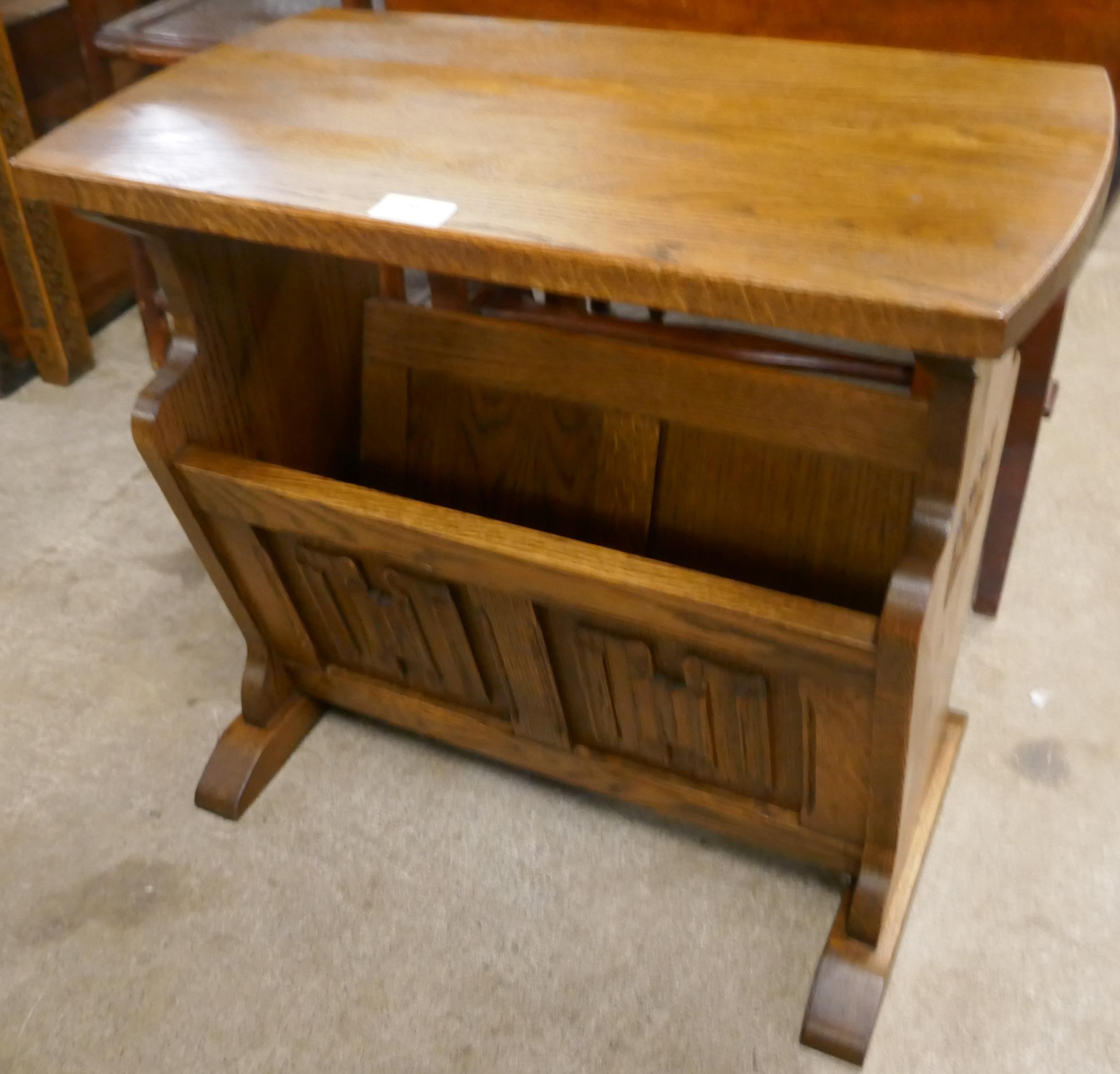 A carved oak linenfold magazine rack