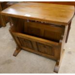 A carved oak linenfold magazine rack