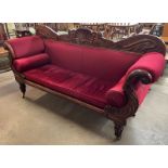 A Regency carved mahogany and red fabric upholstered scroll end settee