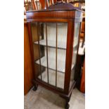 An Edward VII mahogany single door bow front display cabinet