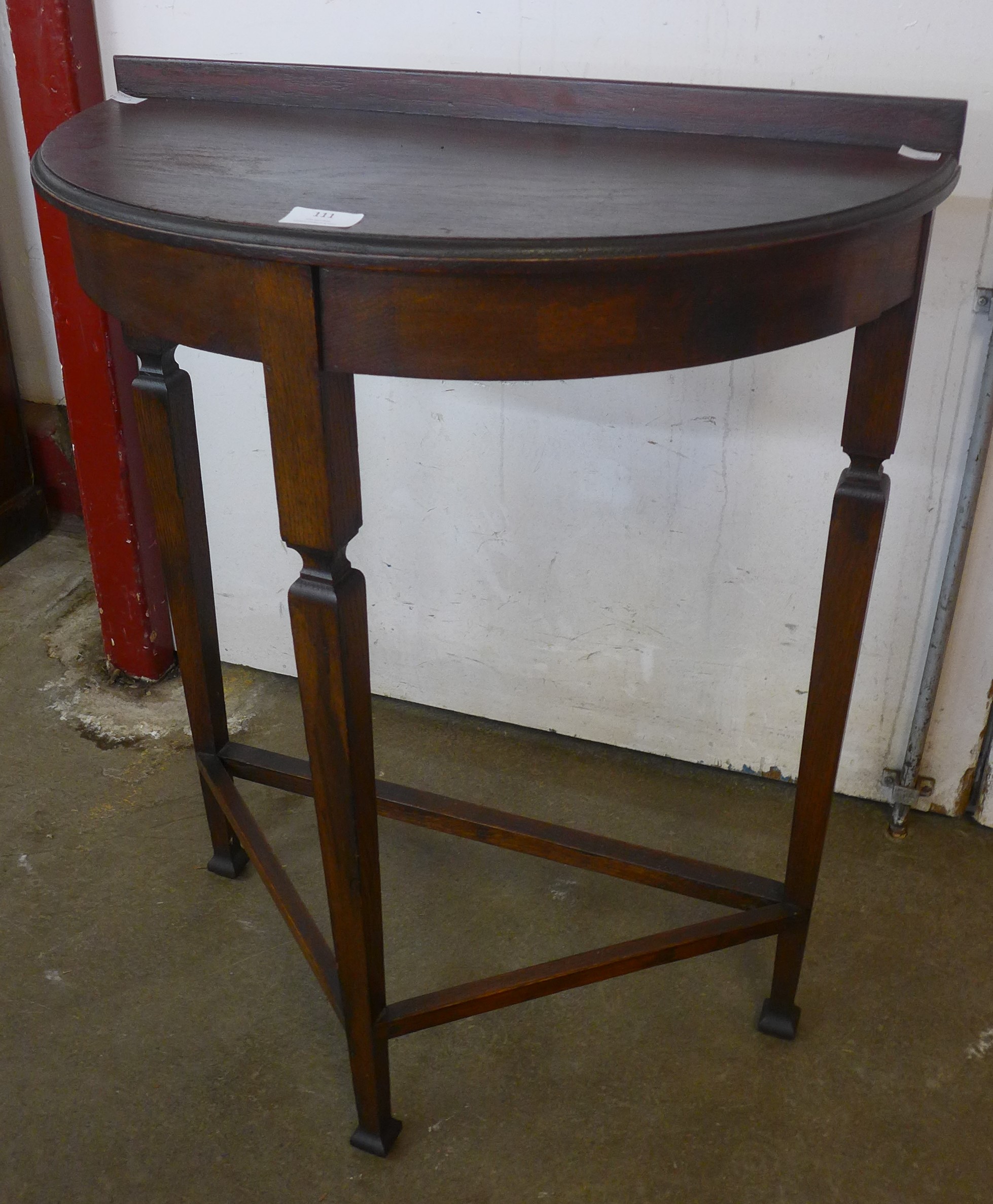 An Edward VII oak demi-lune hall table