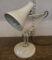 A white metal anglepoise desk lamp