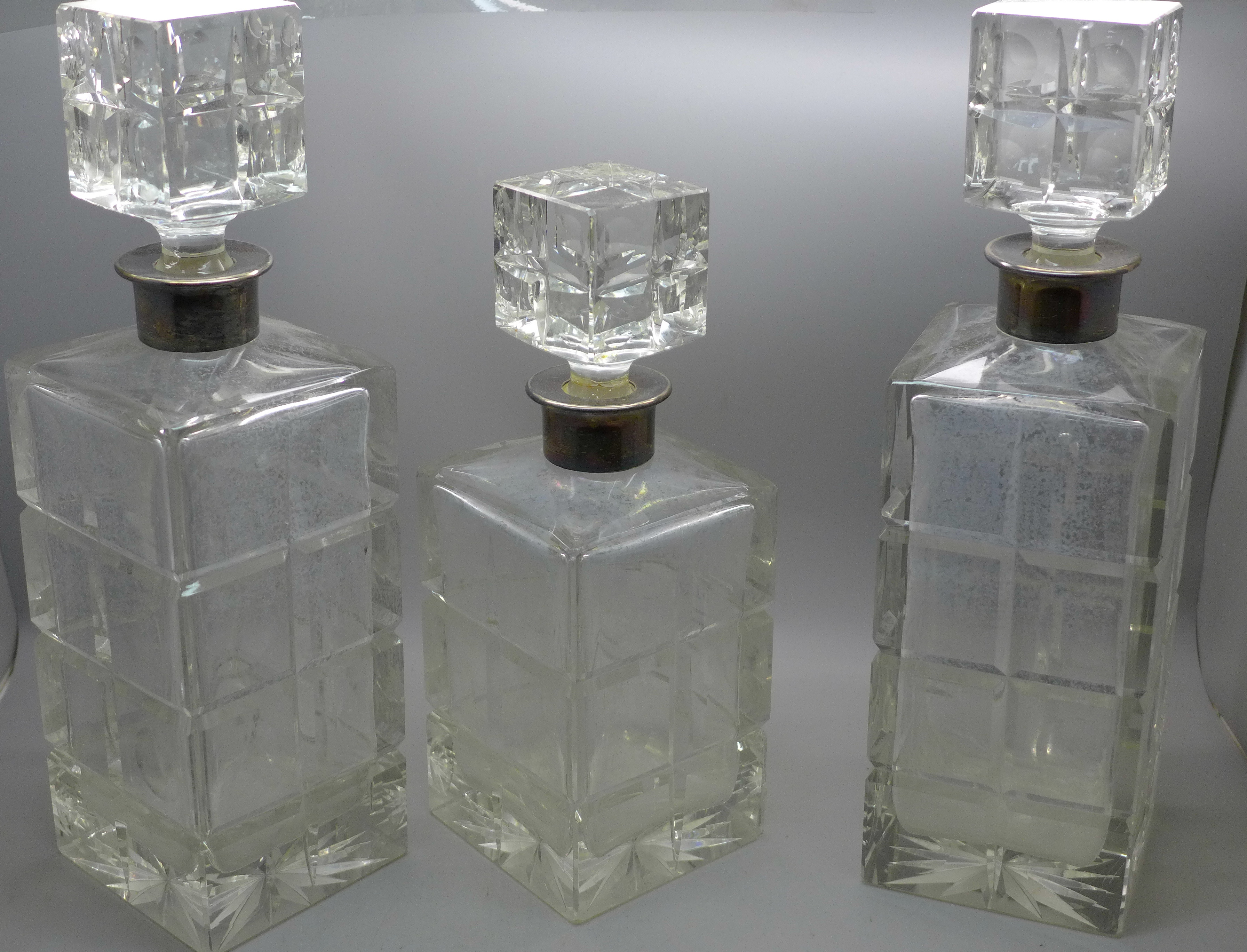 Three heavy crystal decanters (2+1), with silver collars, Israel Freeman & Son Ltd, London 1966 -