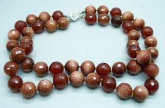 A heavy faceted goldstone and dark red stone bead double string necklace with silver clasp, 278g