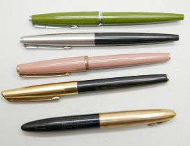 A cased Sheaffer pen with 14k gold nib with four Parker fountain pens